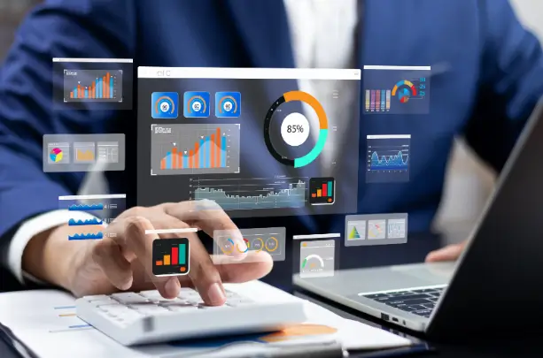 A business professional analyzes data with a calculator and laptop, surrounded by interactive digital graphs and charts.